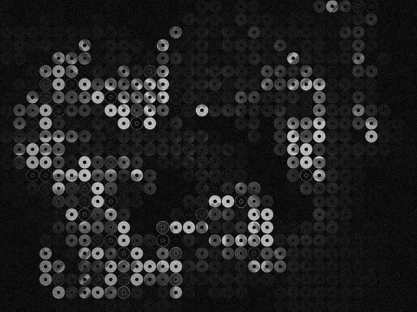 Ein Muster aus Reihen kleiner, kreisförmiger Formen mit hellen Zentren auf dunklem Hintergrund, die so angeordnet sind, dass sie ein abstraktes, schattiertes Bild bilden - wie ein automatisch gespeicherter Entwurf. Die Kreise variieren in ihrer Helligkeit, wodurch Tiefe und Textur entstehen.