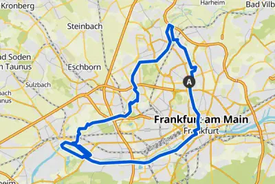 Eine Karte mit einer blau markierten Route rund um Frankfurt am Main. Die Route beginnt am Punkt „A“ und führt durch Gebiete wie Eschborn, Steinbach und Bad Soden am Taunus, bevor sie nach Frankfurt zurückkehrt.
